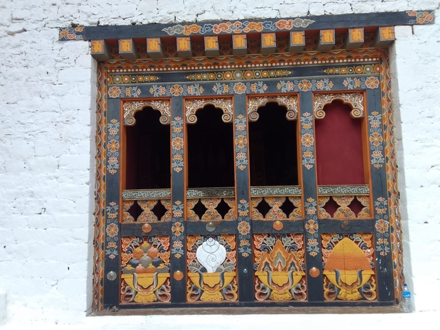 Ornately decorated window of a Bhutanese building.