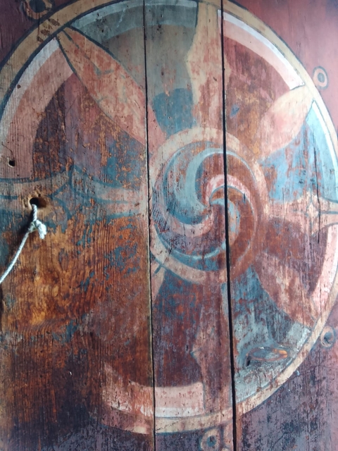 Close-up of a wooden surface with painted geometric patterns.