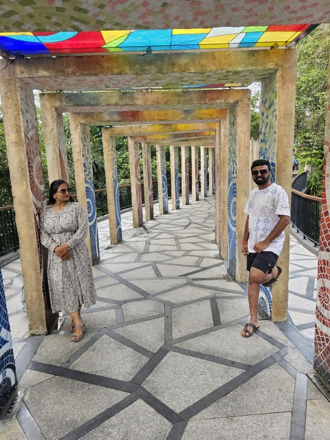       Couple standing between artistic columns.
  