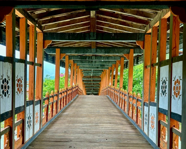       Decorative bridge with detailed wooden carvings.
  