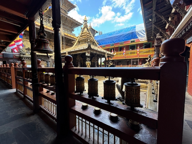       Temple courtyard with spinning prayer wheels.
  