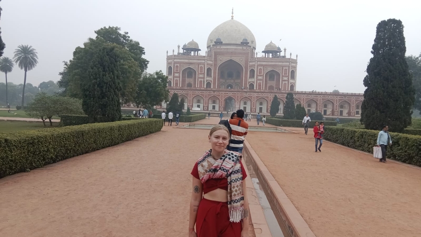 Person standing in front of a historical monument.