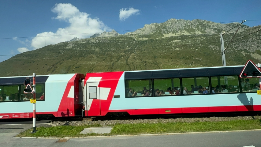       Train passing near a mountain range.
  