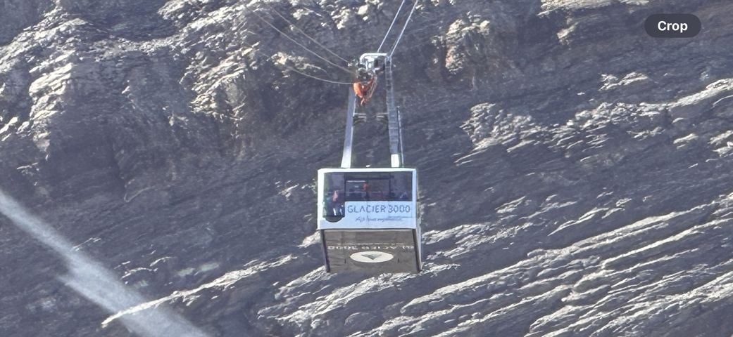 Cable car labeled 'Glacier 3000' in mid-air.