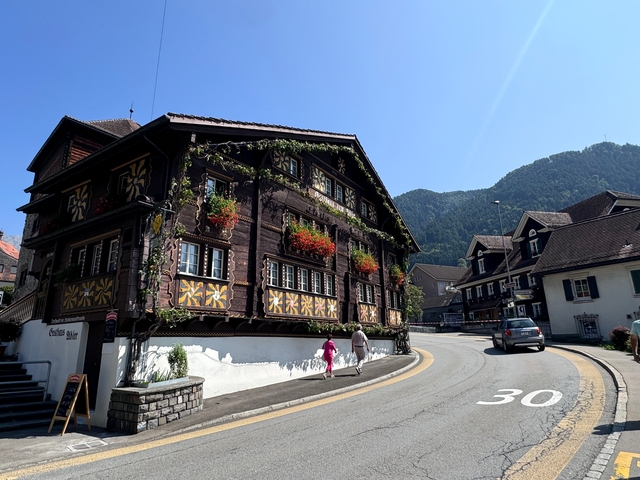 Charming Swiss building next to a road.