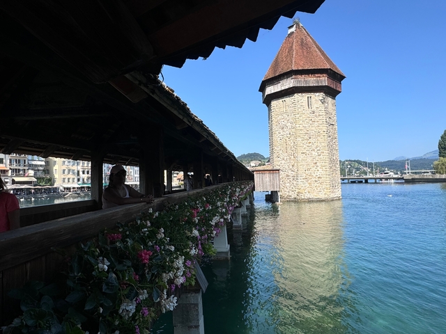       Wooden bridge leading to stone tower.
  