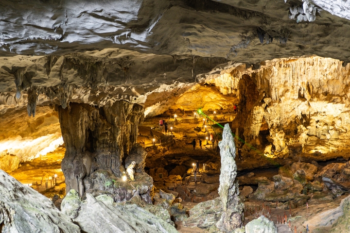 Illuminated cave interior with natural rock formations.