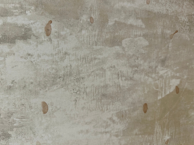Textured wall with a few small stains.