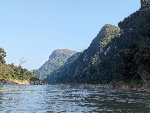       Scenic view of a river cutting through forested mountains.
  