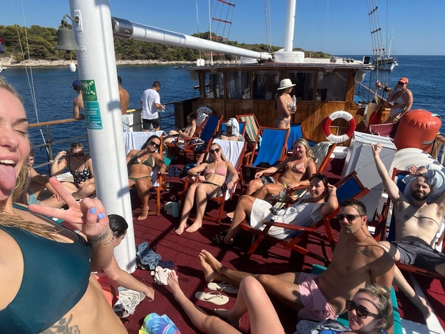 Group of people relaxing on a boat, enjoying the sun.