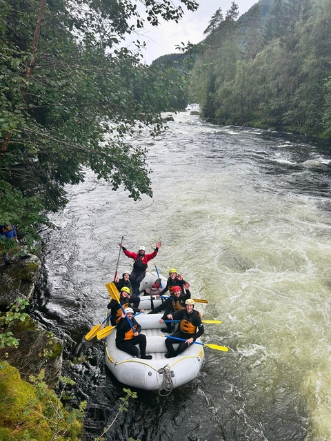       Rafting group on a river with rapids.
  
