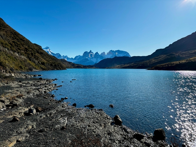 Calm water with mountains in the distance.