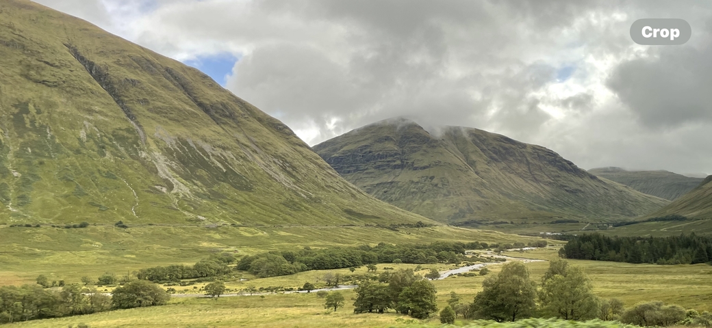       Lush green mountains with clouds overhead.
  