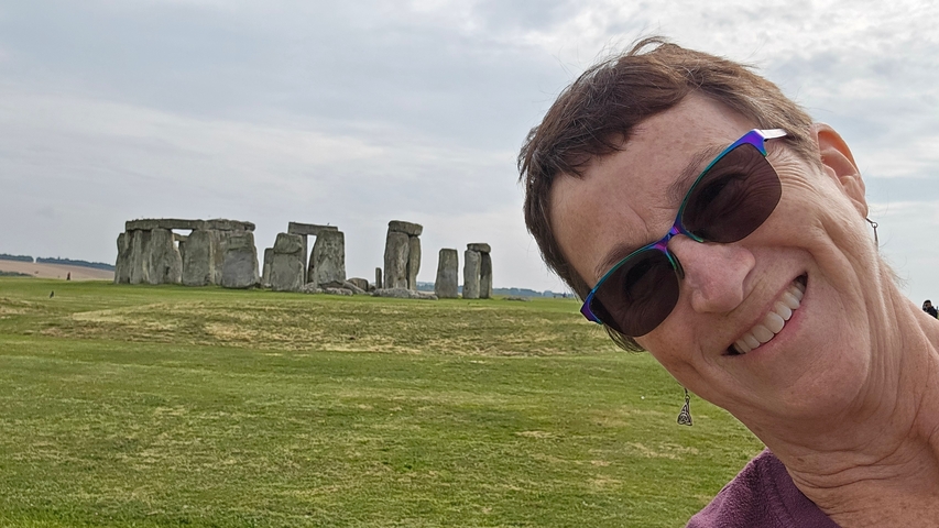 Person taking a selfie with Stonehenge in the background.