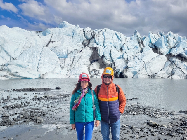       Group photo of people with a glacier backdrop.
  