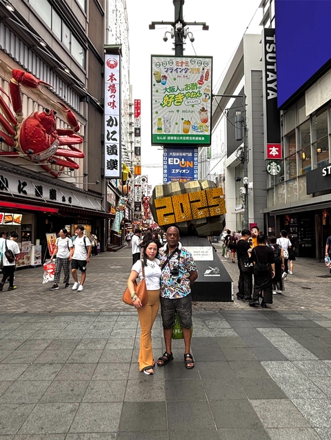       Busy street scene with people and shops in an urban area.
  