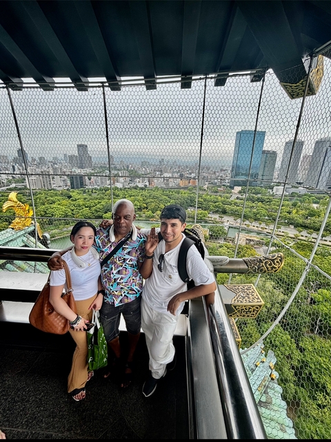       Group of people at a high vantage point overlooking a city.
  