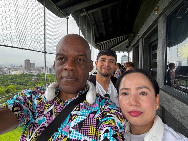       Selfie with people on a city observation deck.
  