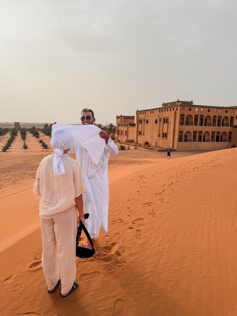Two people in front of a desert hotel