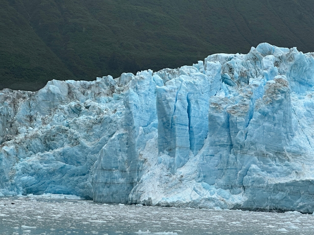 Large blue glacier with a mountain backdrop.
