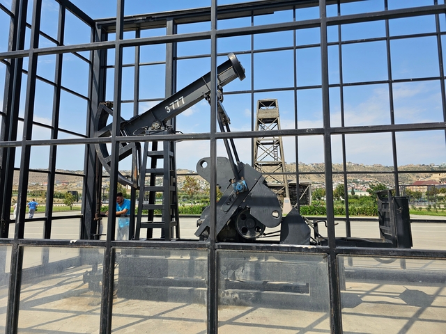 Industrial equipment displayed behind a metal grid.
