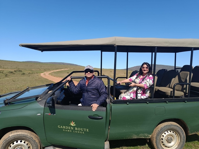 Two people in an open safari vehicle
