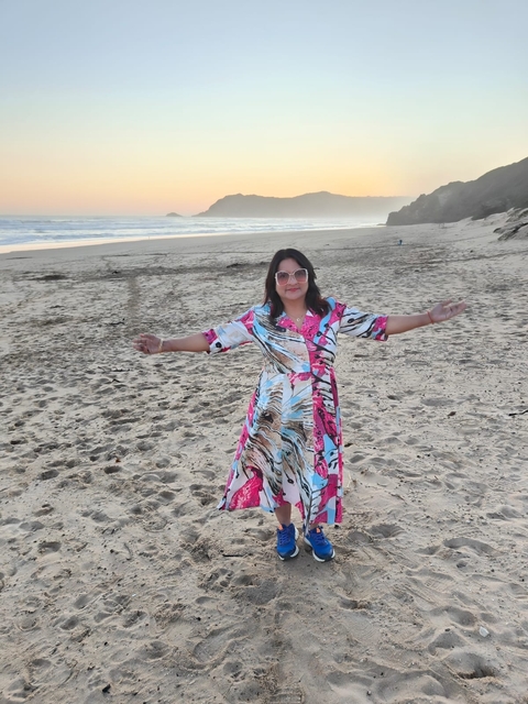Person posing on a sandy beach