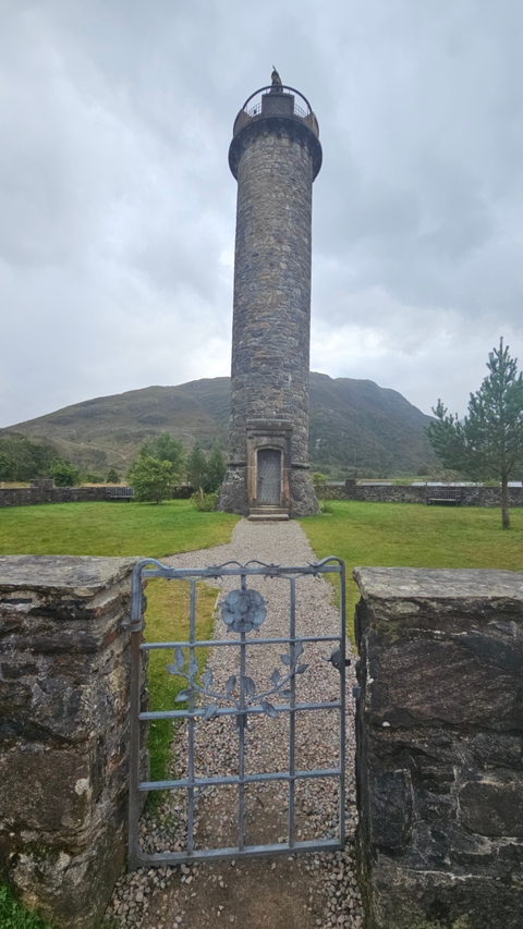 Close-up of a tower set against a mountain backdrop.