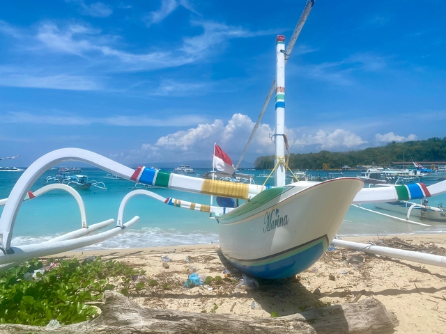 Traditional boat on a sandy beach with clear water
