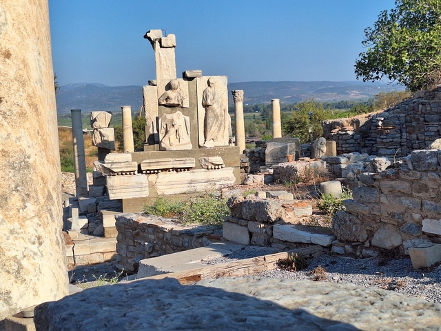 Ancient ruins with mountains in the distance.