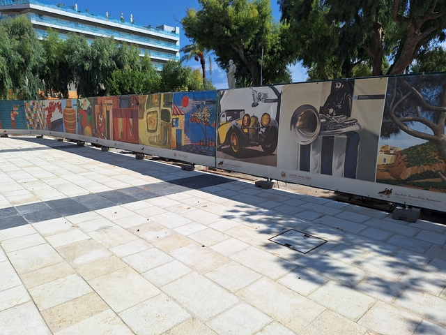Outdoor art display with colorful paintings.