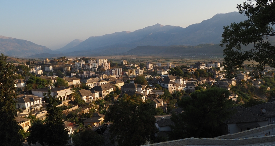 Scenic view of a town with mountains in the background.