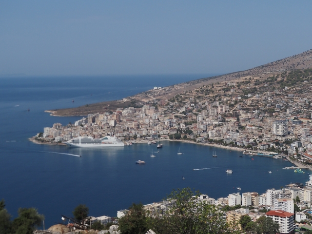 Coastal town with a cruise ship in the harbor.