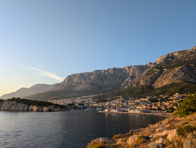 Coastal city with mountains in the background.