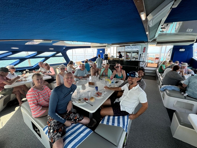 Group of people dining on a boat.