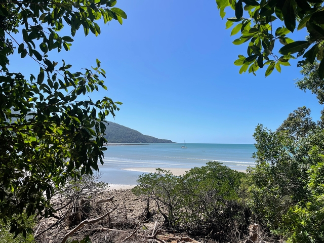 Scenic beach view with clear blue water.