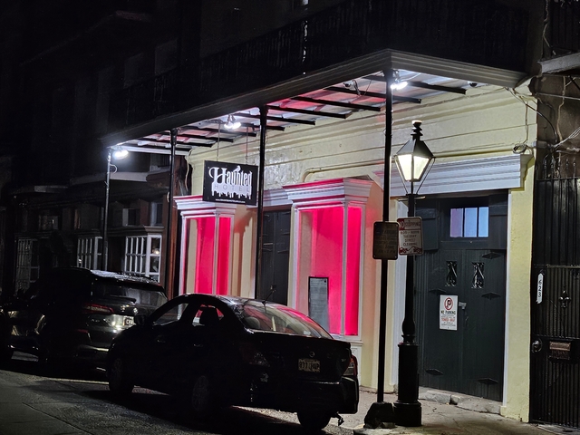 Exterior of a building with colorful lighting at night.