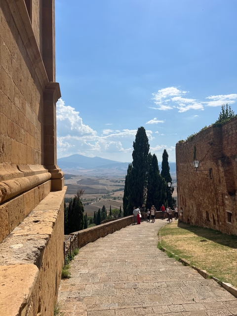 People enjoying a scenic hilltop view in Tuscany.