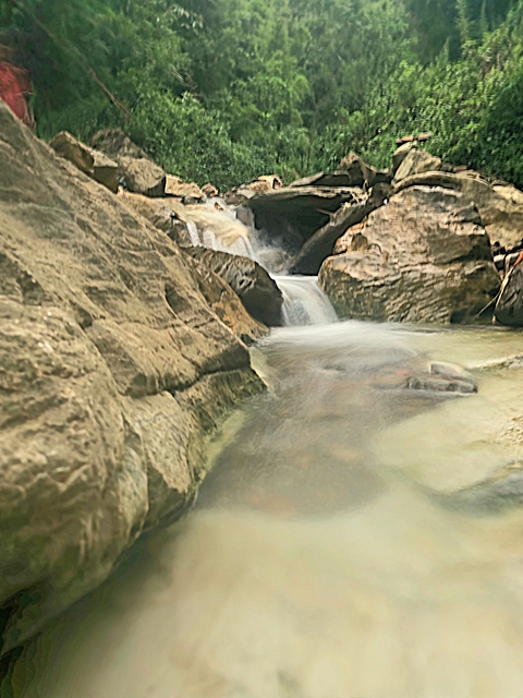 Small waterfall flowing over rocks.