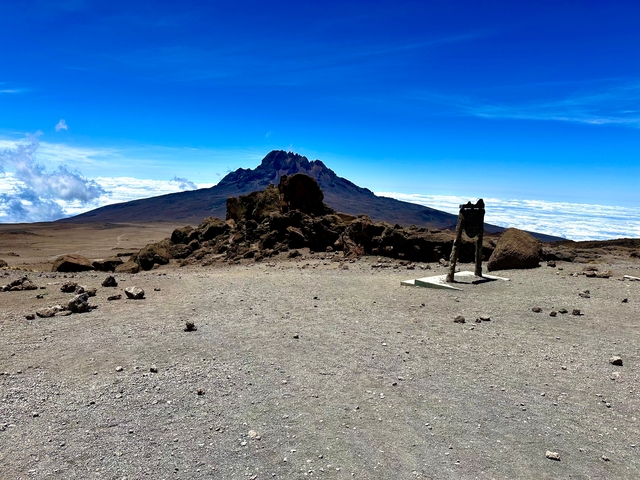 Distant view of a mountain peak against a clear sky.