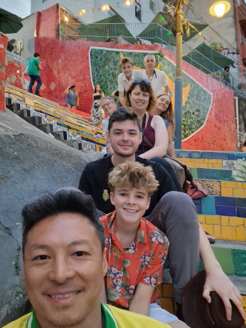 Family on colorful stairs with artistic tiles.