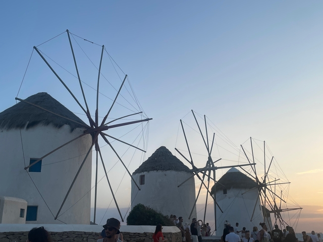 Traditional windmills at sunset with clear sky.