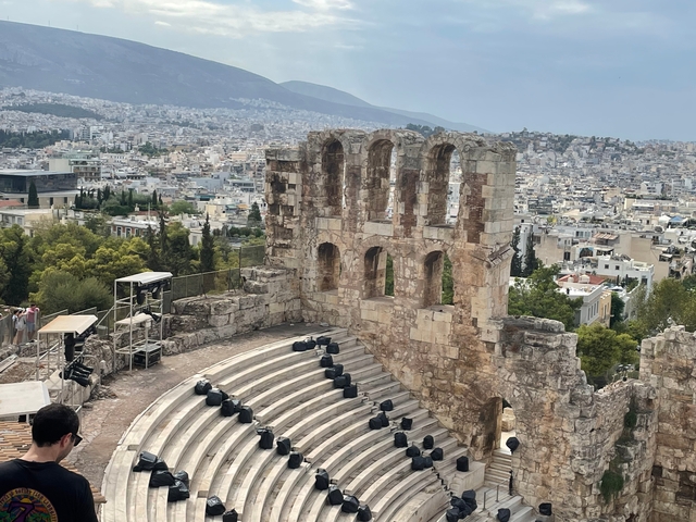 Ancient amphitheater with a view of the city in the background.