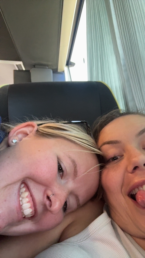 Close-up of two women smiling on a vehicle.