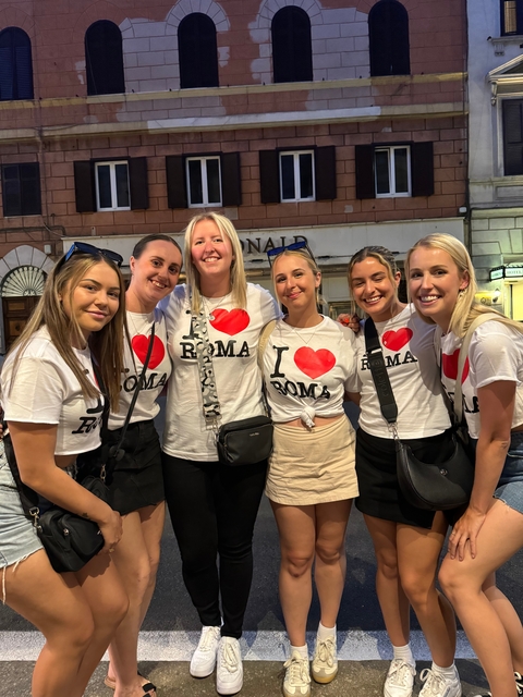 Group of friends wearing 'I love Roma' shirts.