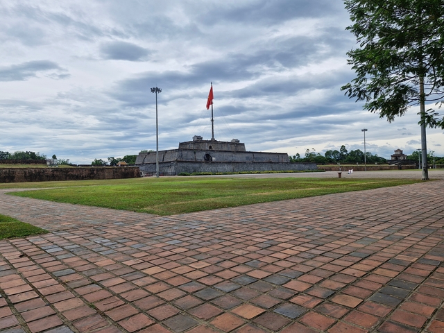 Historical stone citadel with a flag.