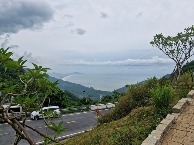 Curved coastal road with a view of the ocean.