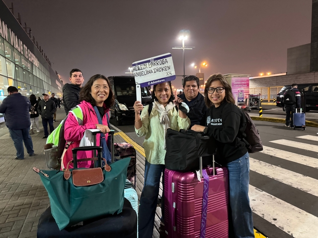 Group of women with luggage at an airport.