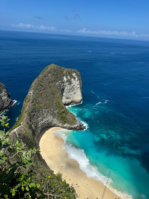 Cliff formation by the ocean with turquoise waters.