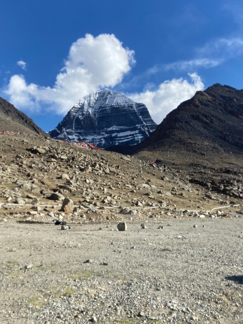 Mountainous landscape with snow on peaks and rocky terrain.